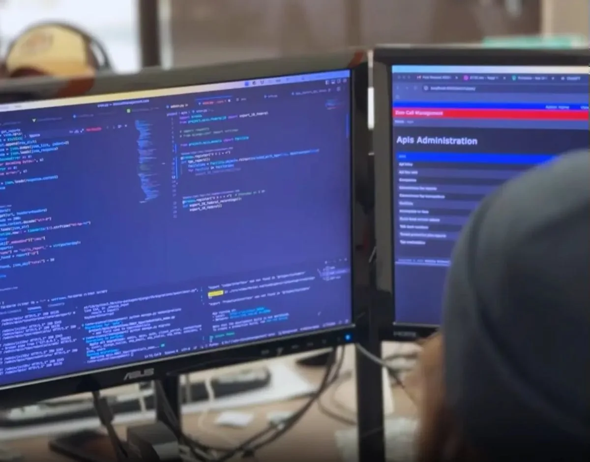 Virgo Development engineer working on API integration code on dual monitors